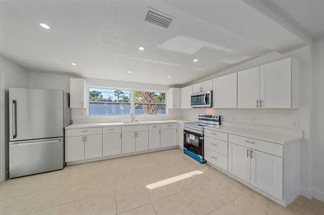 a room with cabinets and white appliances