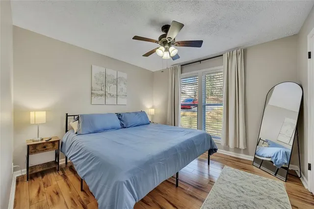 a bedroom with a bed and a mirror