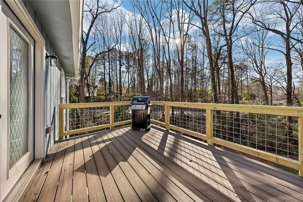 a view of a balcony with wooden floor and fence