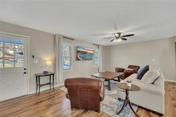 a living room with furniture and wooden floor