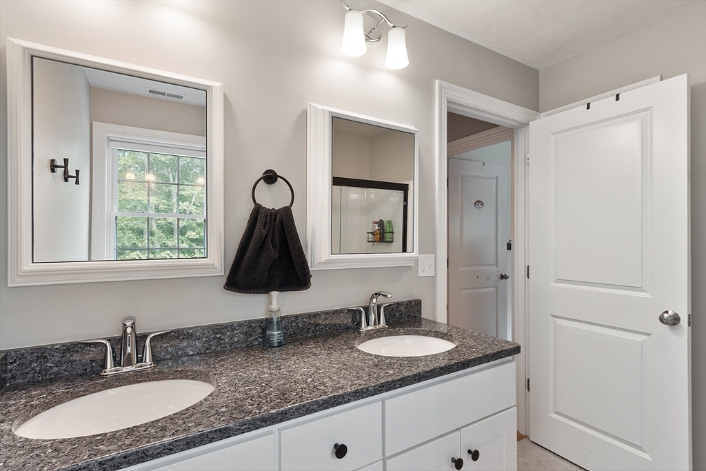 46 Jordan Road Holden, MA 01520 - Photo 27 of 42 a bathroom with a granite countertop sink and a mirror