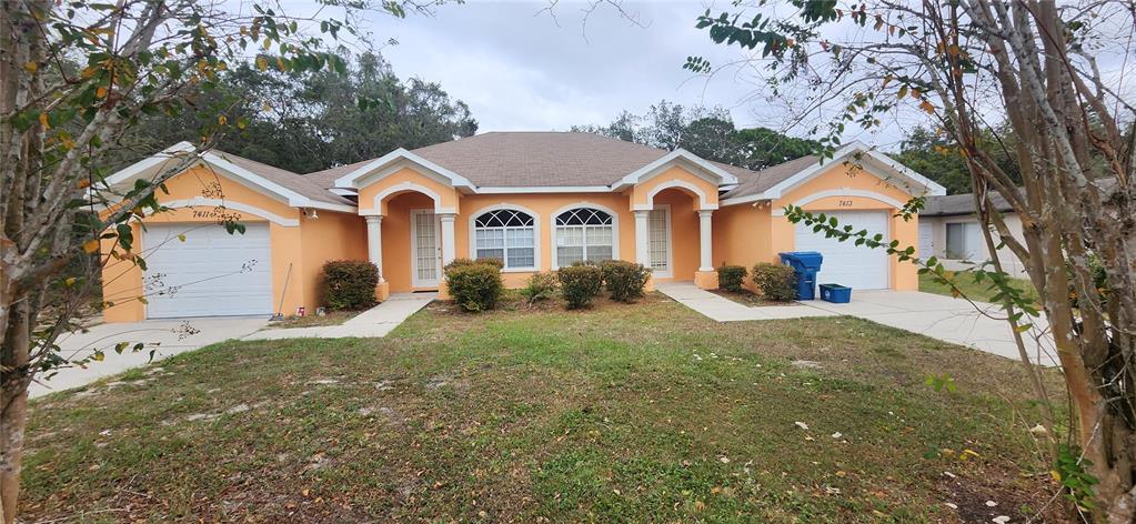 a front view of a house with a yard and garage