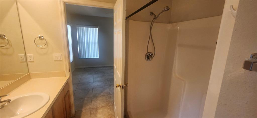 7411 Canterbury Street Spring Hill, FL 34606 - Photo 13 of 28 a bathroom with a shower and a toilet