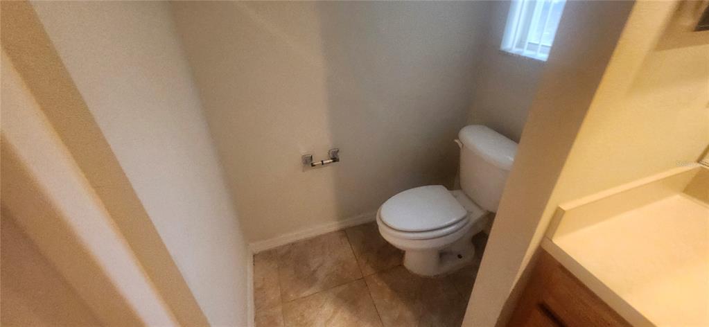 7411 Canterbury Street Spring Hill, FL 34606 - Photo 14 of 28 a white toilet sitting next to a sink