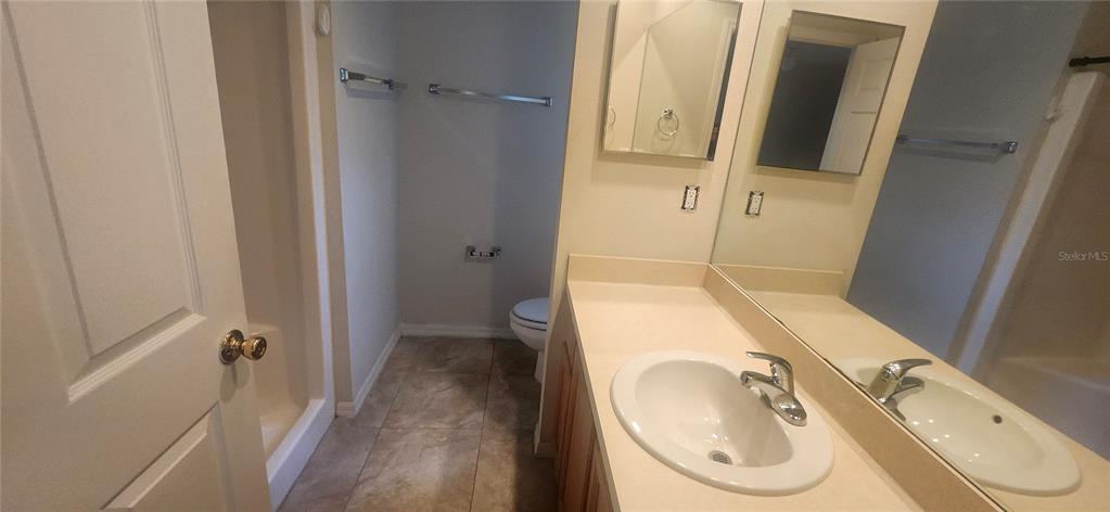 7411 Canterbury Street Spring Hill, FL 34606 - Photo 15 of 28 a bathroom with a sink a toilet and a shower