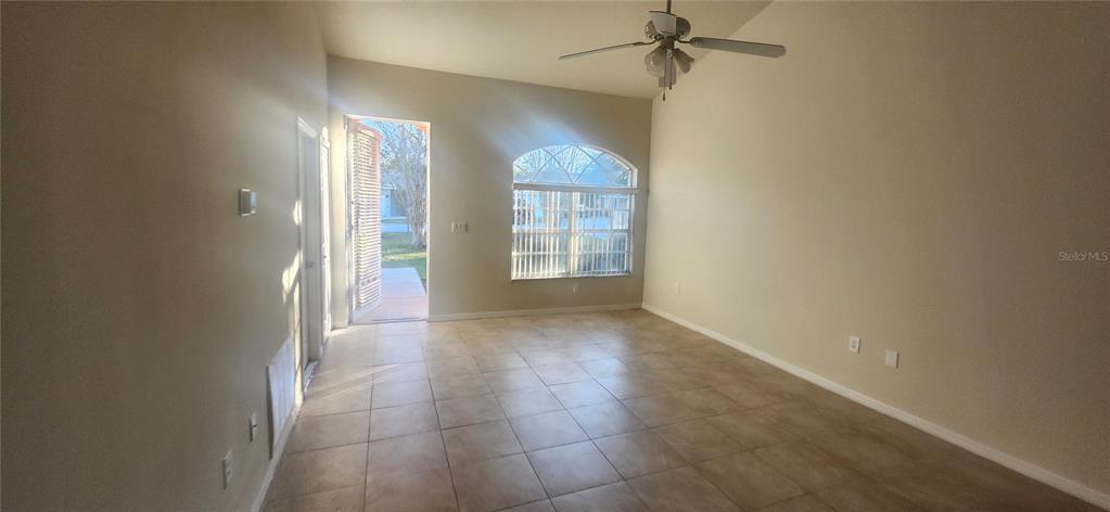 7411 Canterbury Street Spring Hill, FL 34606 - Photo 17 of 28 an empty room with windows and fan