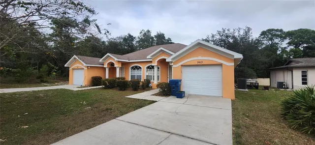 a front view of a house with a yard and garage