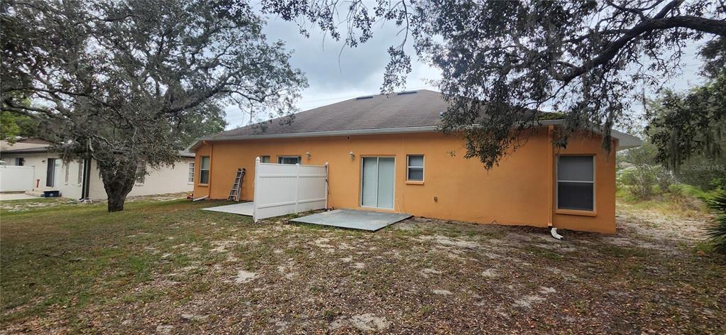 7411 Canterbury Street Spring Hill, FL 34606 - Photo 23 of 28 a house with trees in front of it