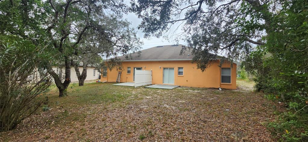 7411 Canterbury Street Spring Hill, FL 34606 - Photo 24 of 28 a house that has a tree in front of it