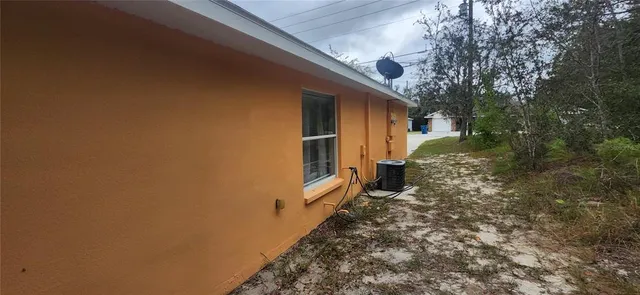 a yellow house with trees in front of it