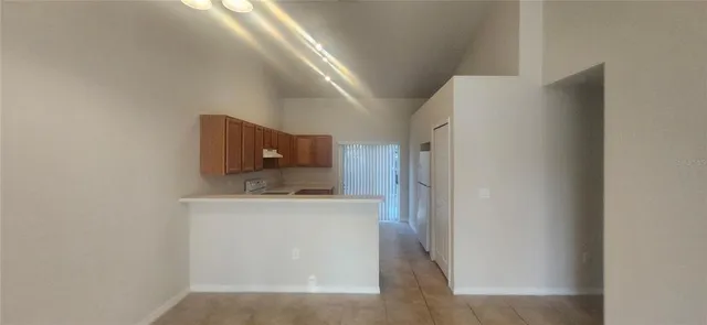 a kitchen with stainless steel appliances a refrigerator and a stove