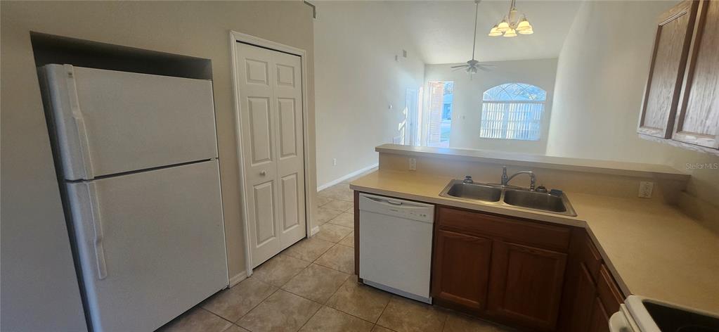 7411 Canterbury Street Spring Hill, FL 34606 - Photo 6 of 28 a kitchen with stainless steel appliances granite countertop a refrigerator a sink and a stove