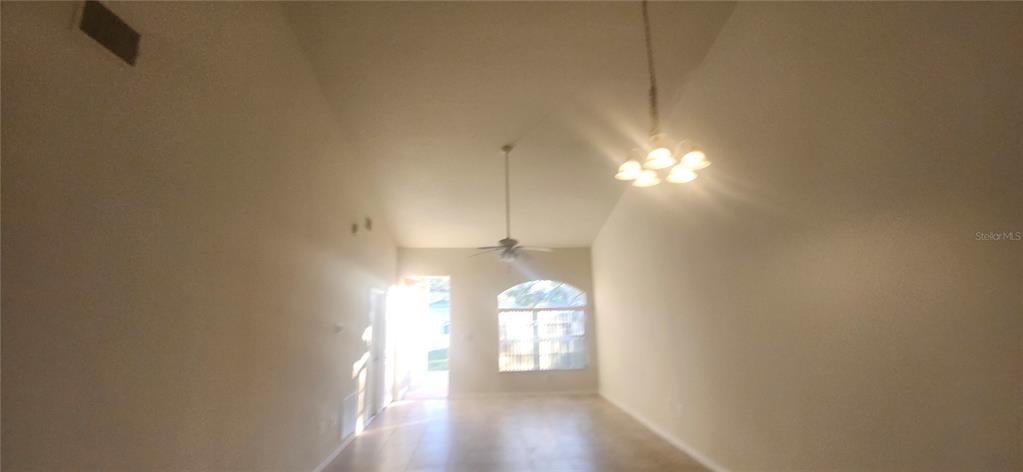 7411 Canterbury Street Spring Hill, FL 34606 - Photo 7 of 28 a view of a room with window and chandelier