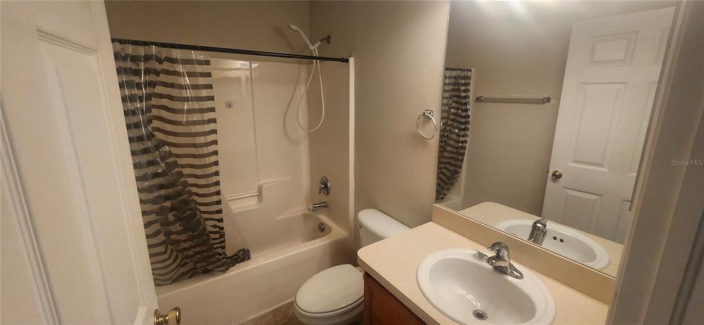 7411 Canterbury Street Spring Hill, FL 34606 - Photo 9 of 28 a bathroom with a sink toilet and shower