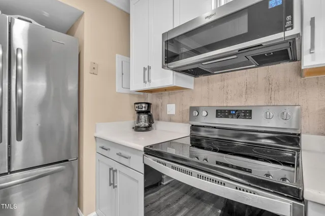 a stove top oven sitting inside of a kitchen