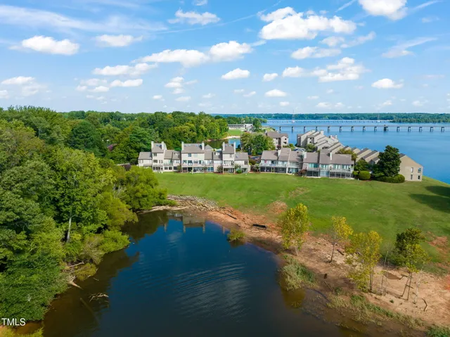 a view of a lake with houses in the background