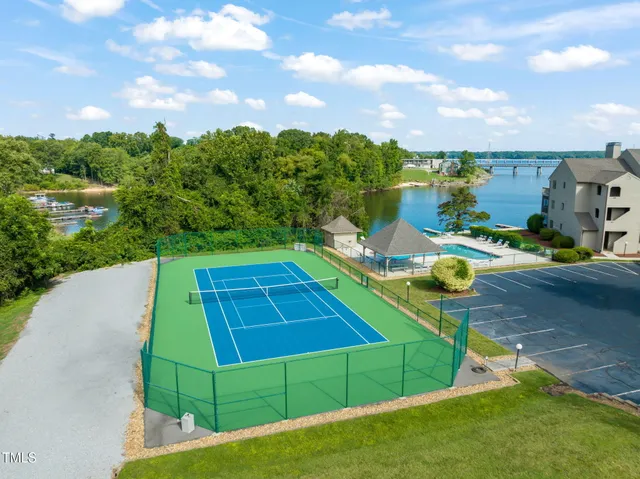 a view of a tennis ground with a swimming pool