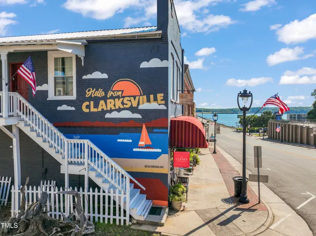 a view of staircase with railing and a chandelier