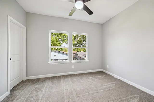 an empty room with a window and wooden floor
