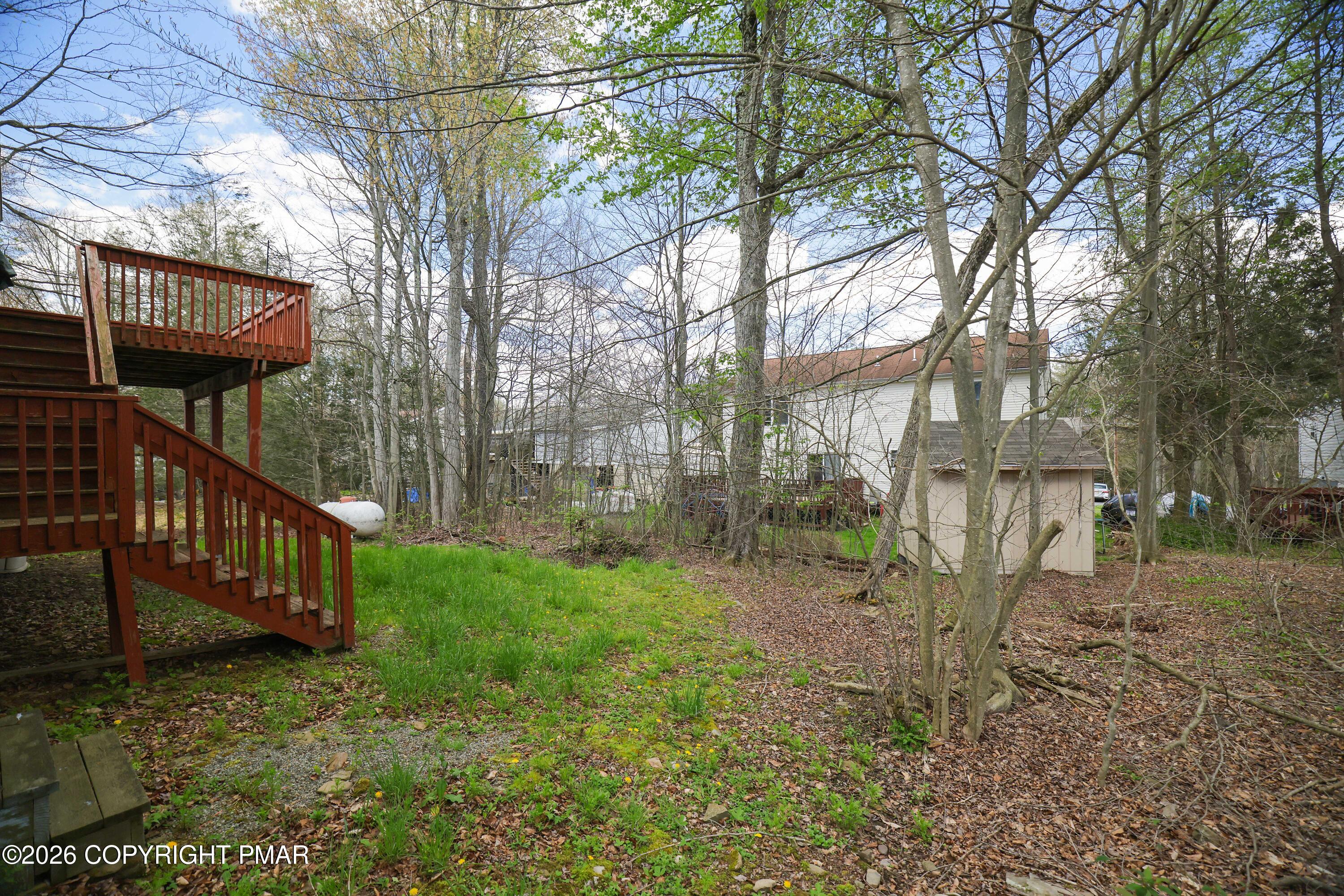 2137 Freedom Way Pocono Summit, PA 18346 - Photo 31 of 71 a view of a yard with large trees and a wooden fence