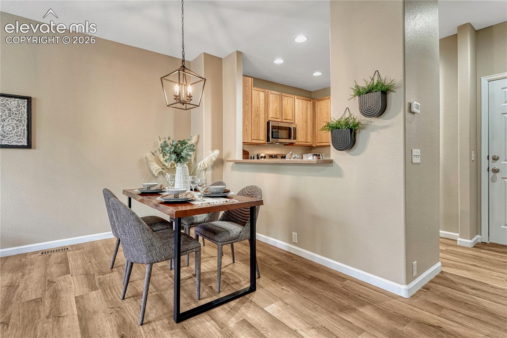 4147 Diamond Ridge View Colorado Springs, CO 80918 - Photo 8 of 42 This open-concept dining area seamlessly connects to the kitchen and living spaces, creating a warm, sophisticated setting for effortless entertaining and memorable meals