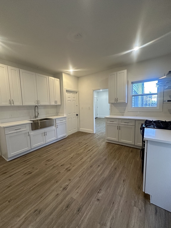 62 West 6th Street, Unit 1 Lowell, MA 01850 - Photo 3 of 11 a kitchen with a refrigerator and a stove top oven