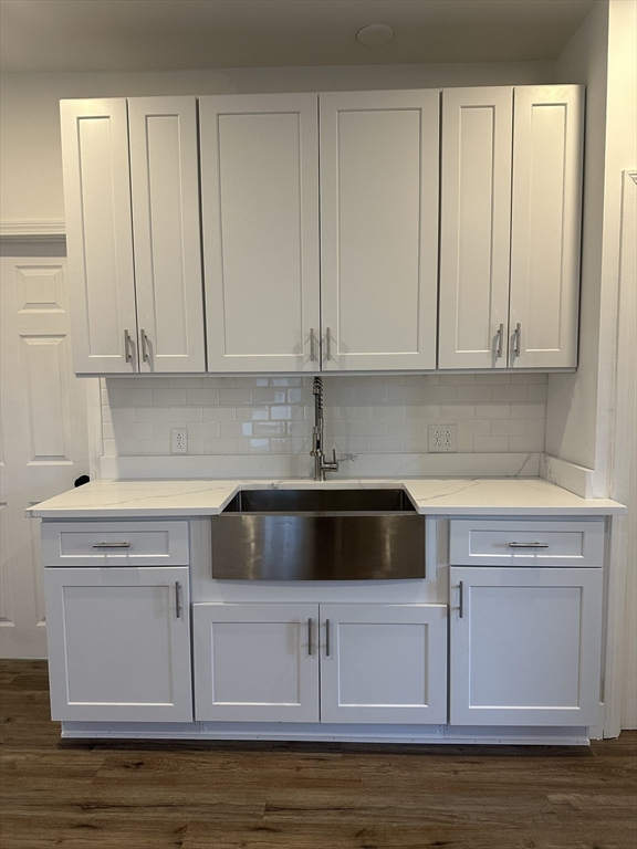 62 West 6th Street, Unit 1 Lowell, MA 01850 - Photo 4 of 11 a kitchen with granite countertop white cabinets and a stove