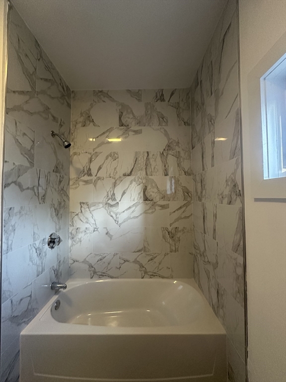 62 West 6th Street, Unit 1 Lowell, MA 01850 - Photo 6 of 11 a bathroom with a bathtub
