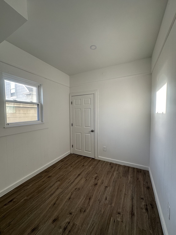 62 West 6th Street, Unit 1 Lowell, MA 01850 - Photo 10 of 11 a view of an empty room with wooden floor and a window