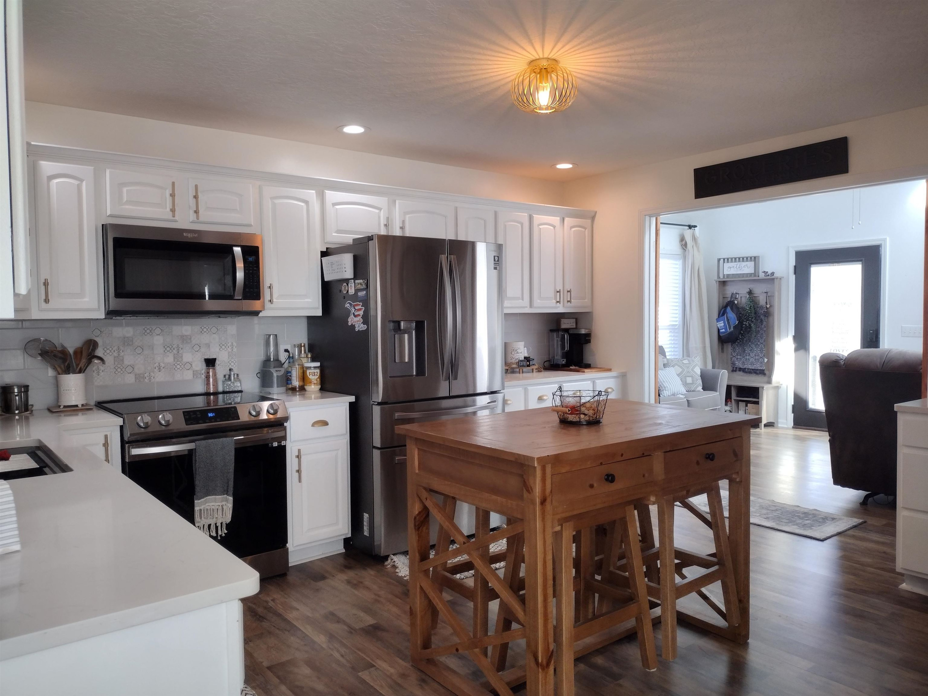 360 Parham Road Martin, TN 38237 - Photo 15 of 32 a kitchen with stainless steel appliances kitchen island granite countertop a refrigerator a stove a sink a dining table and chairs