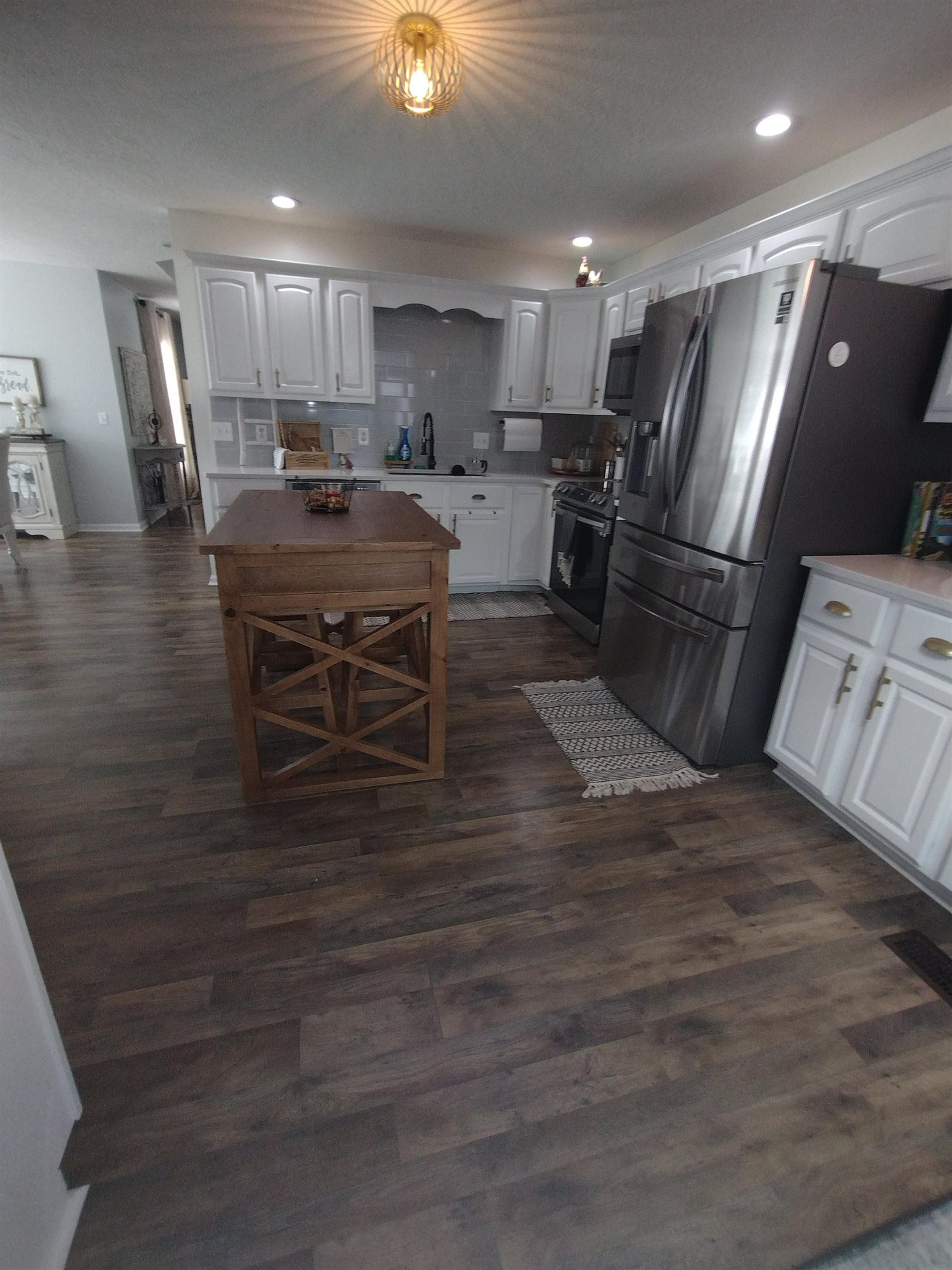 360 Parham Road Martin, TN 38237 - Photo 16 of 32 a kitchen with stainless steel appliances wooden floor dining table chairs cabinets and a sink
