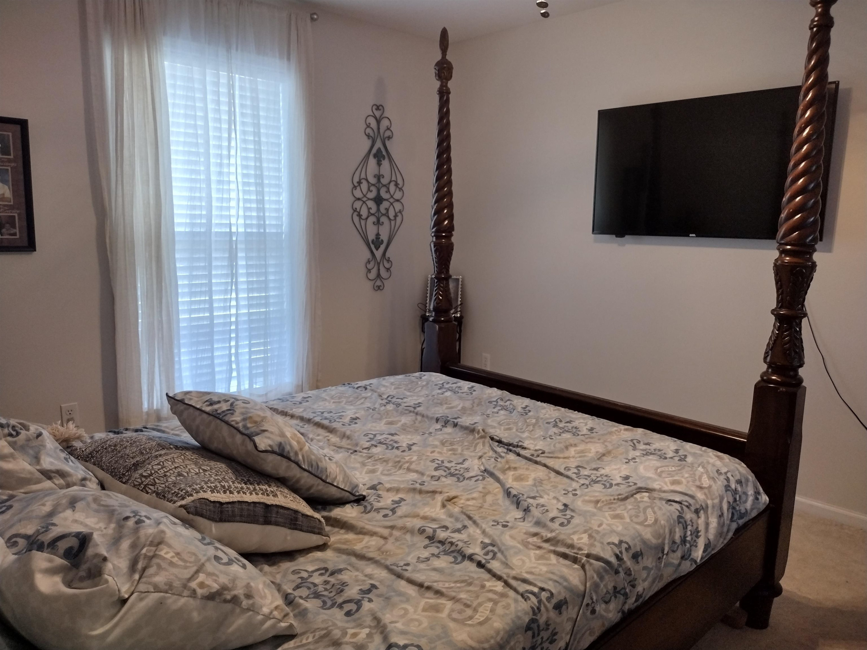 360 Parham Road Martin, TN 38237 - Photo 27 of 32 a bedroom with a bed and flat screen tv