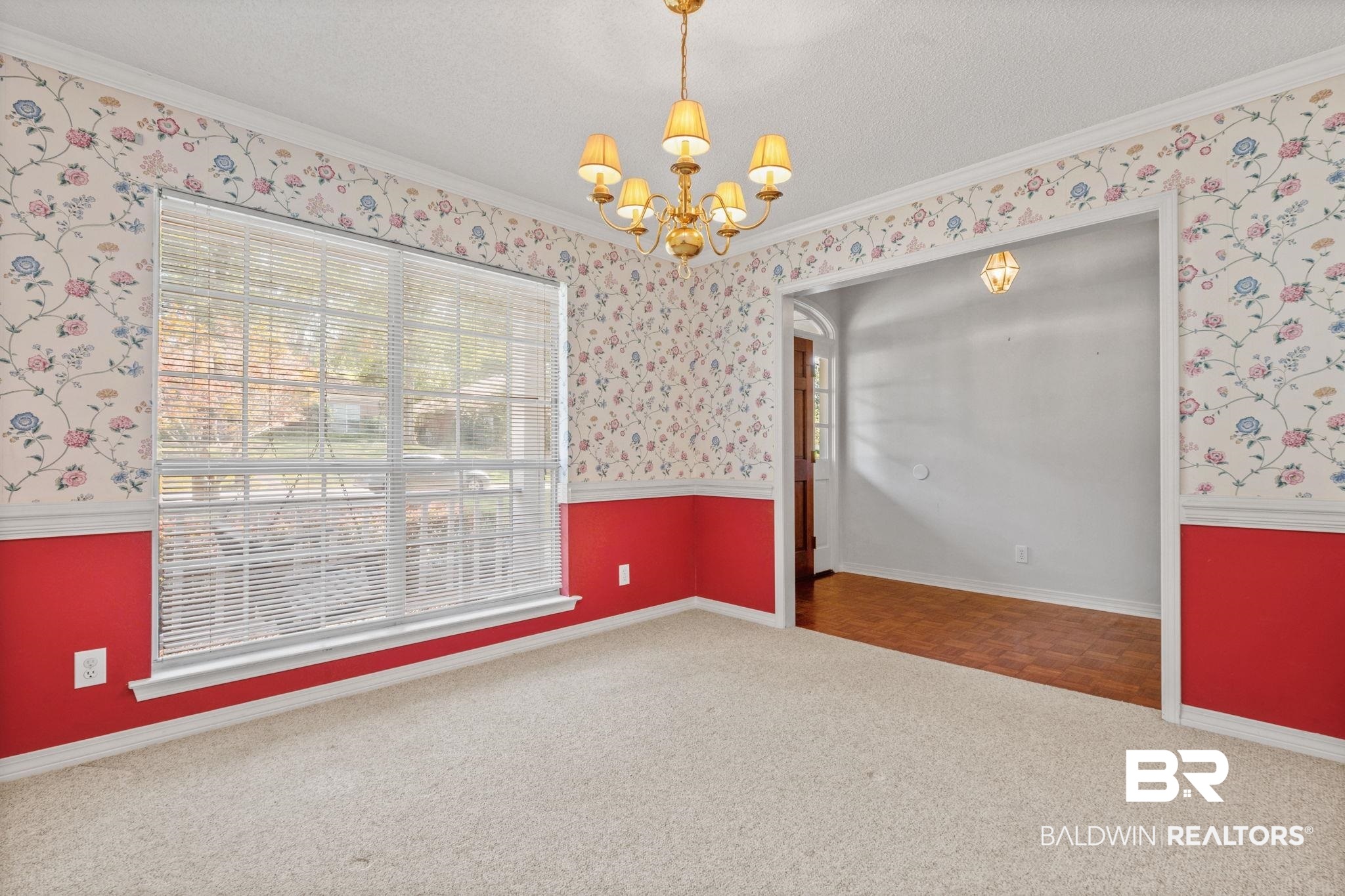1340 Wellsley Court Mobile, AL 36695 - Photo 13 of 37 Carpeted spare room featuring crown molding, a chandelier, a textured ceiling, and wallpapered walls