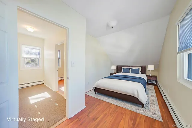 a bedroom with a bed and a view of walk in closet