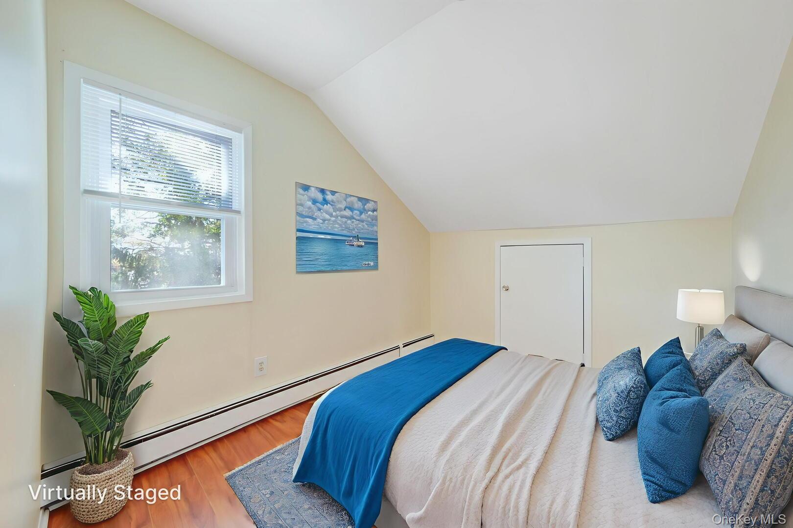 39 Chapman Place, Unit 2 Bay Shore, NY 11706 - Photo 13 of 17 a bedroom with a bed and a potted plant