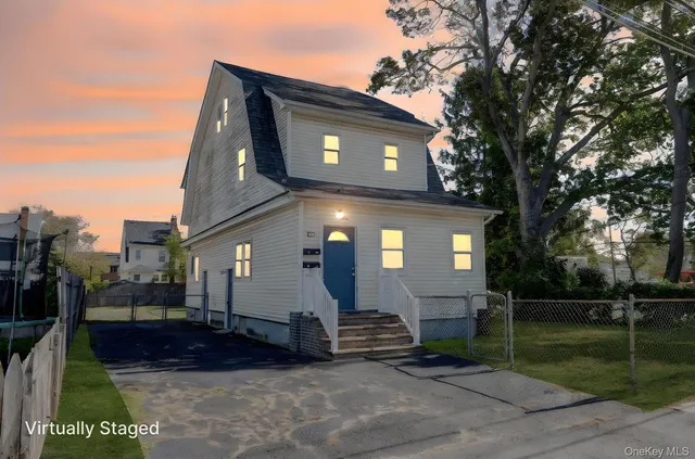 a view of house with a yard