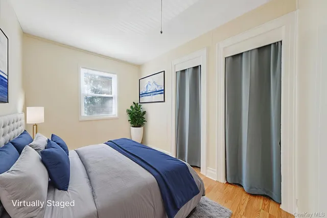 a bedroom with a bed and a window