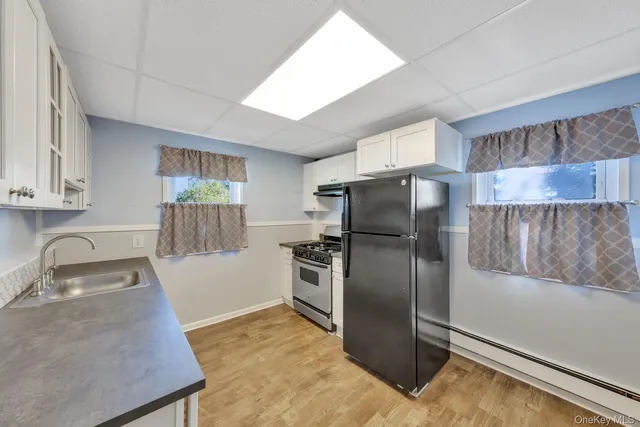a kitchen with granite countertop a refrigerator and a sink