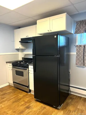 a kitchen with a refrigerator and a sink