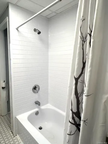a bathroom with a bathtub and shower