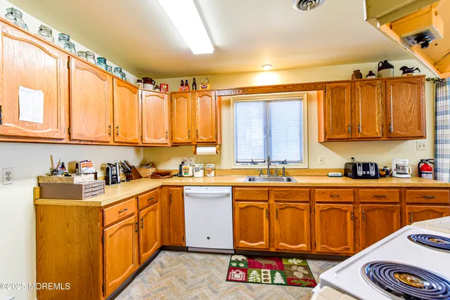 a living room with stainless steel appliances kitchen island granite countertop furniture and a kitchen view