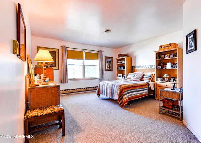 a spacious bedroom with a bed and cabinets