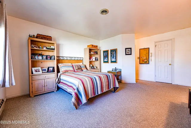 a living room with stainless steel appliances kitchen island granite countertop a sink and a wooden cabinets