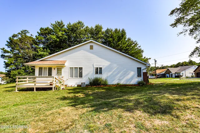 a view of a house with barbeque and wooden floor