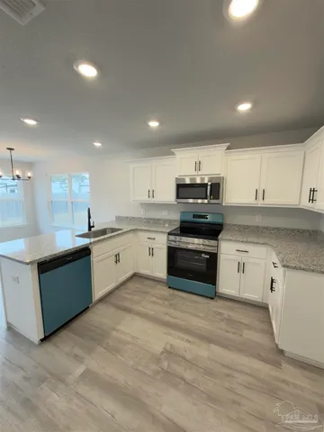 a kitchen with stainless steel appliances granite countertop a sink and cabinets