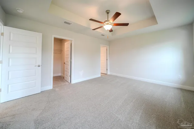 an empty room with closet and wooden floor