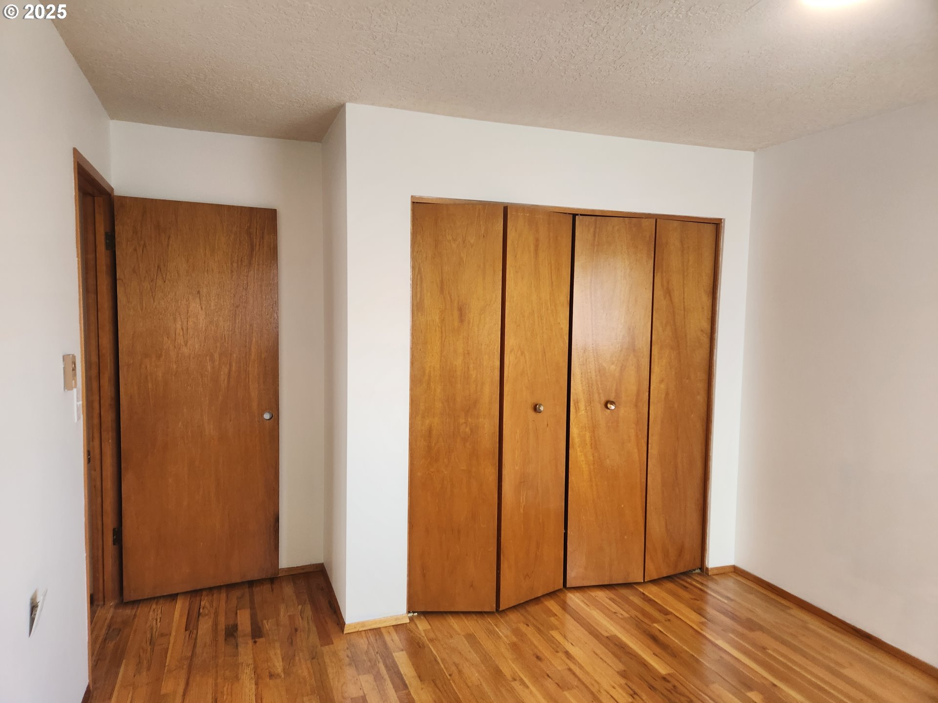 2207 Oregon Court Woodburn, OR 97071 - Photo 13 of 27 a view of an empty room with wooden floor and entrance