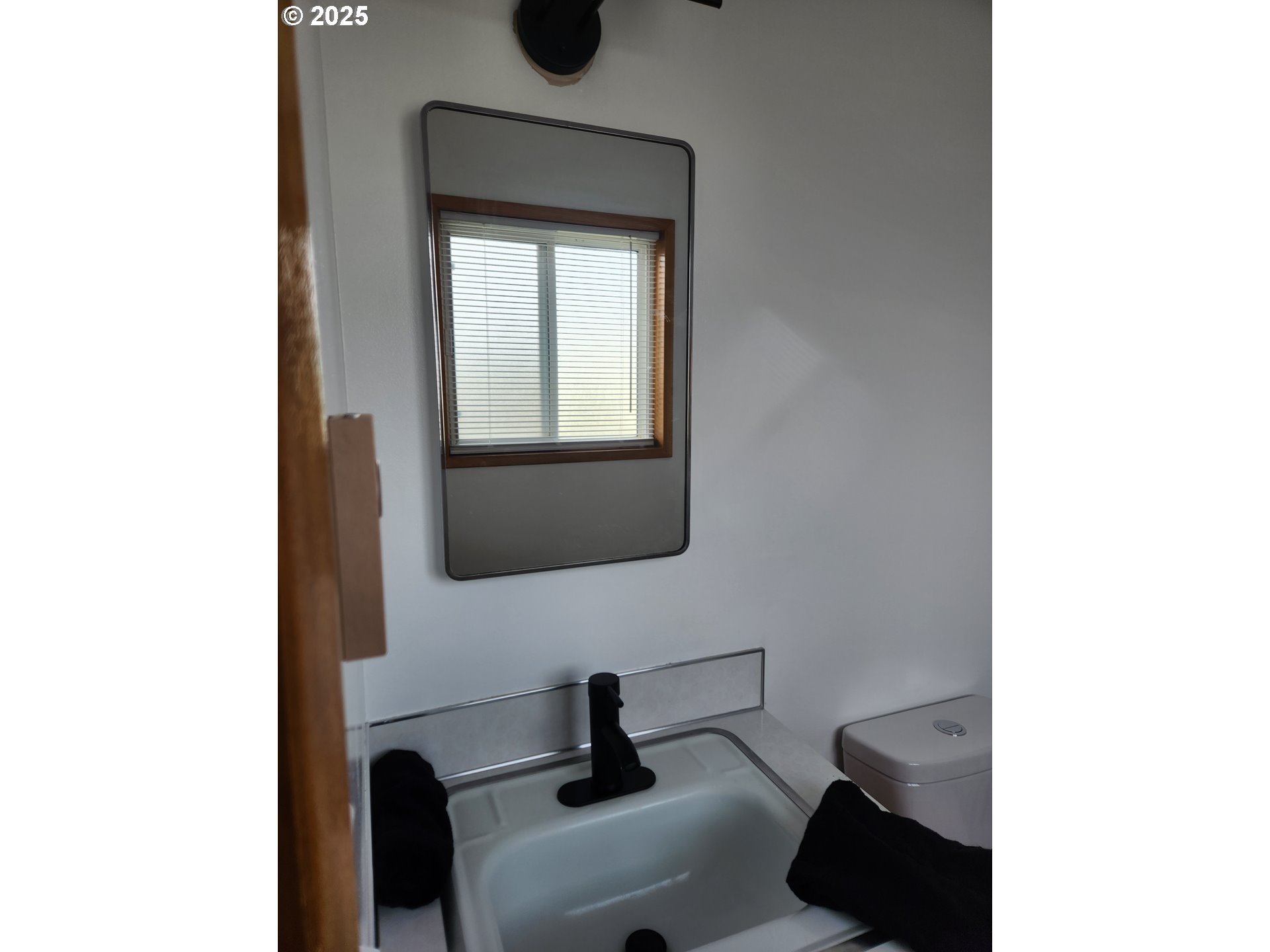 2207 Oregon Court Woodburn, OR 97071 - Photo 14 of 27 a bathroom with a toilet sink and mirror