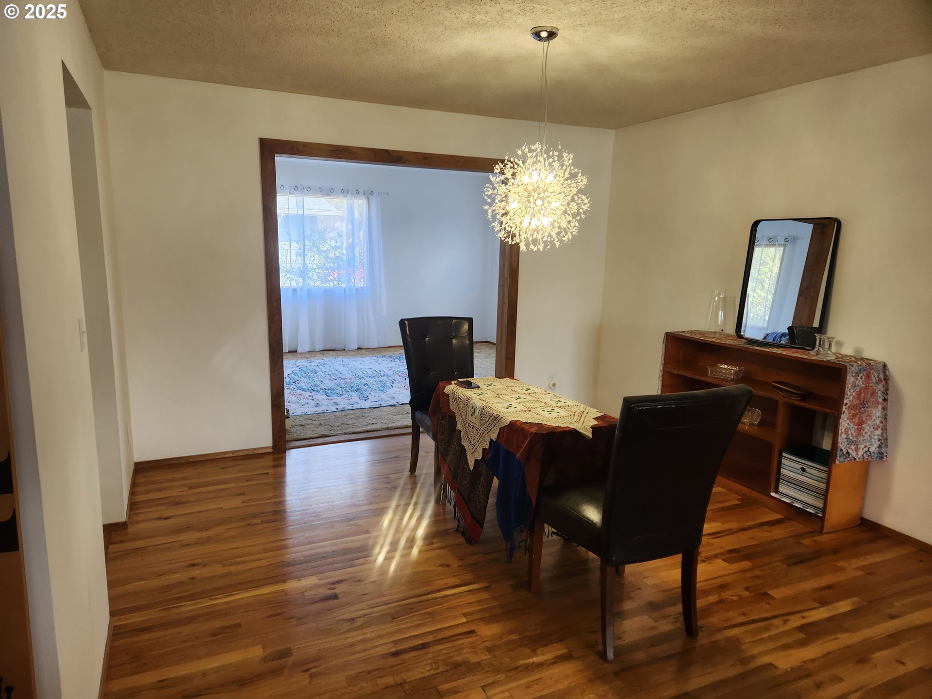 2207 Oregon Court Woodburn, OR 97071 - Photo 4 of 27 a view of a dining room with furniture and wooden floor