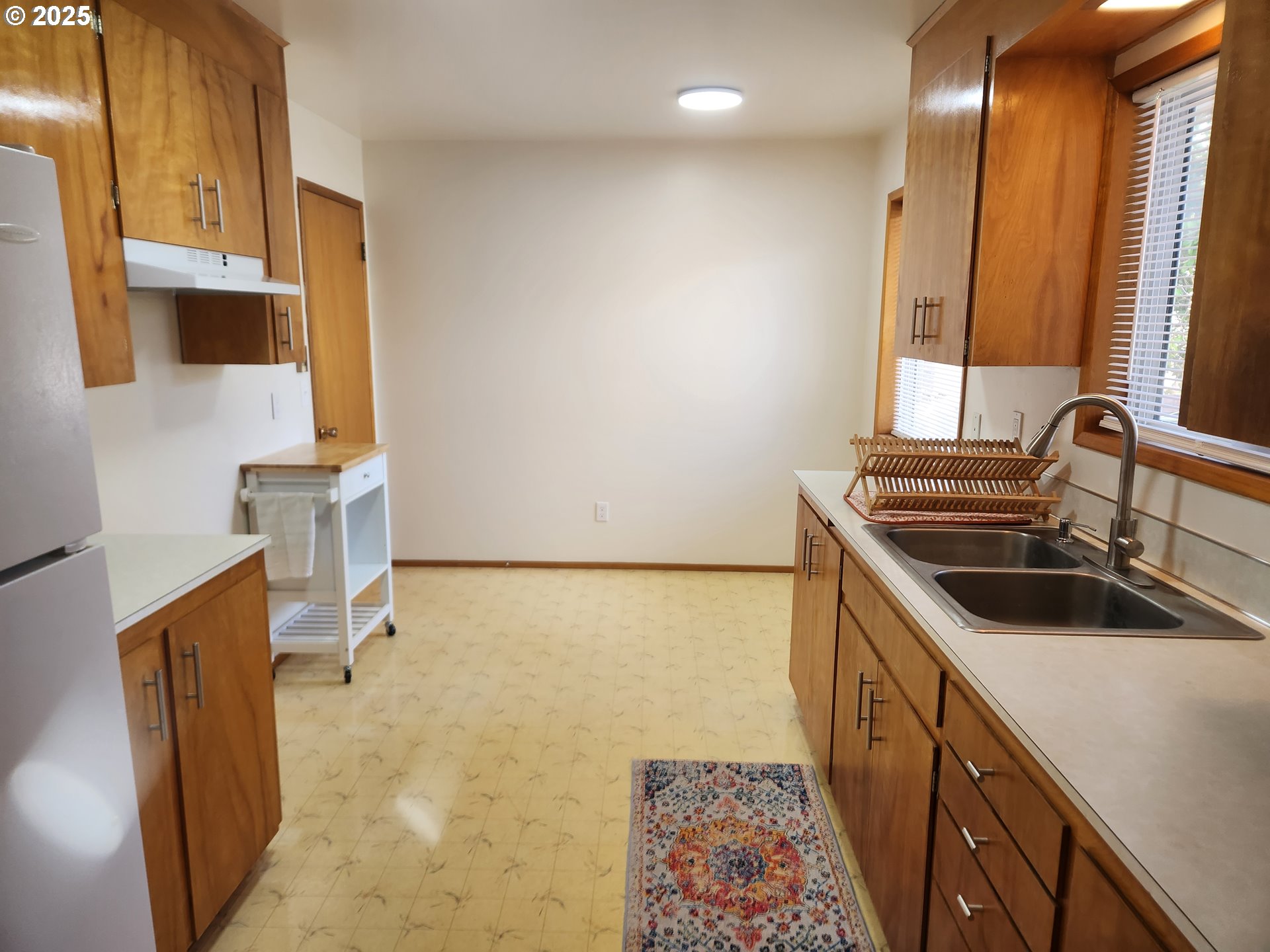 2207 Oregon Court Woodburn, OR 97071 - Photo 6 of 27 a kitchen with a sink a stove and cabinets